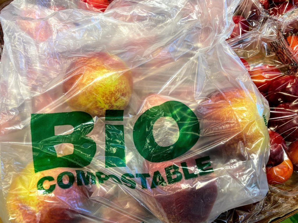 bio compostable plastic bag full of apples