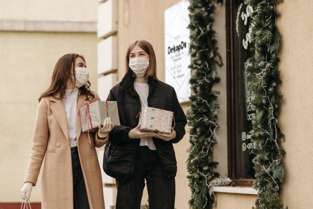 women wearing surgical masks while christmas shoppping