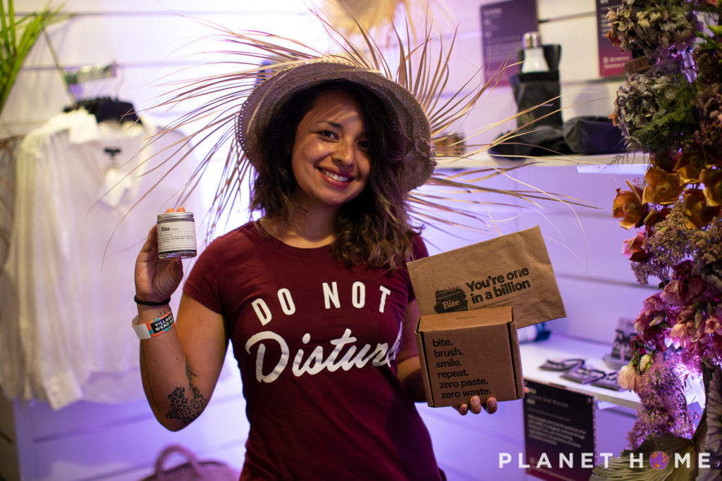 woman holding sustainable products in the Planet Home shop