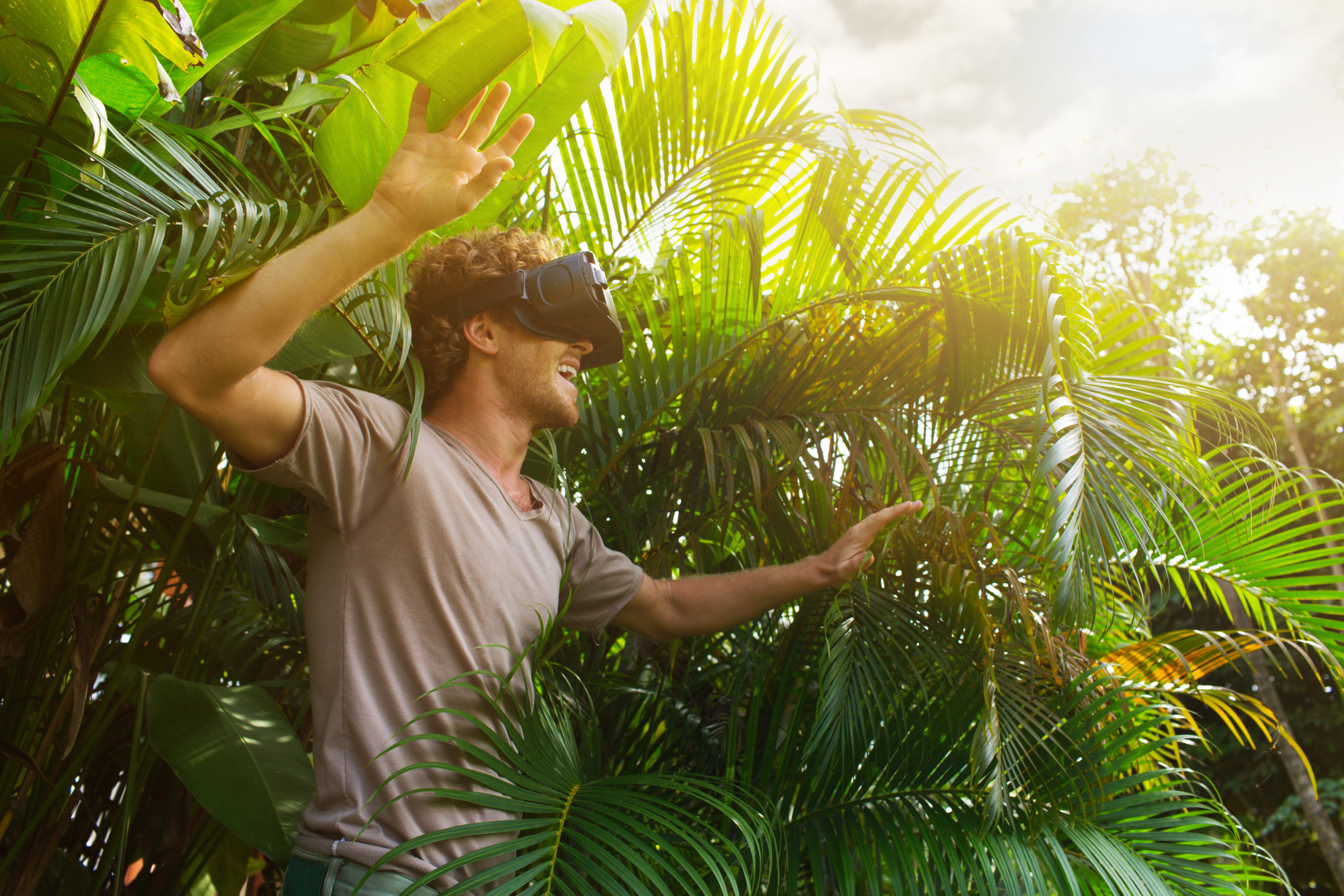 man wearing VR headset and standing in nature