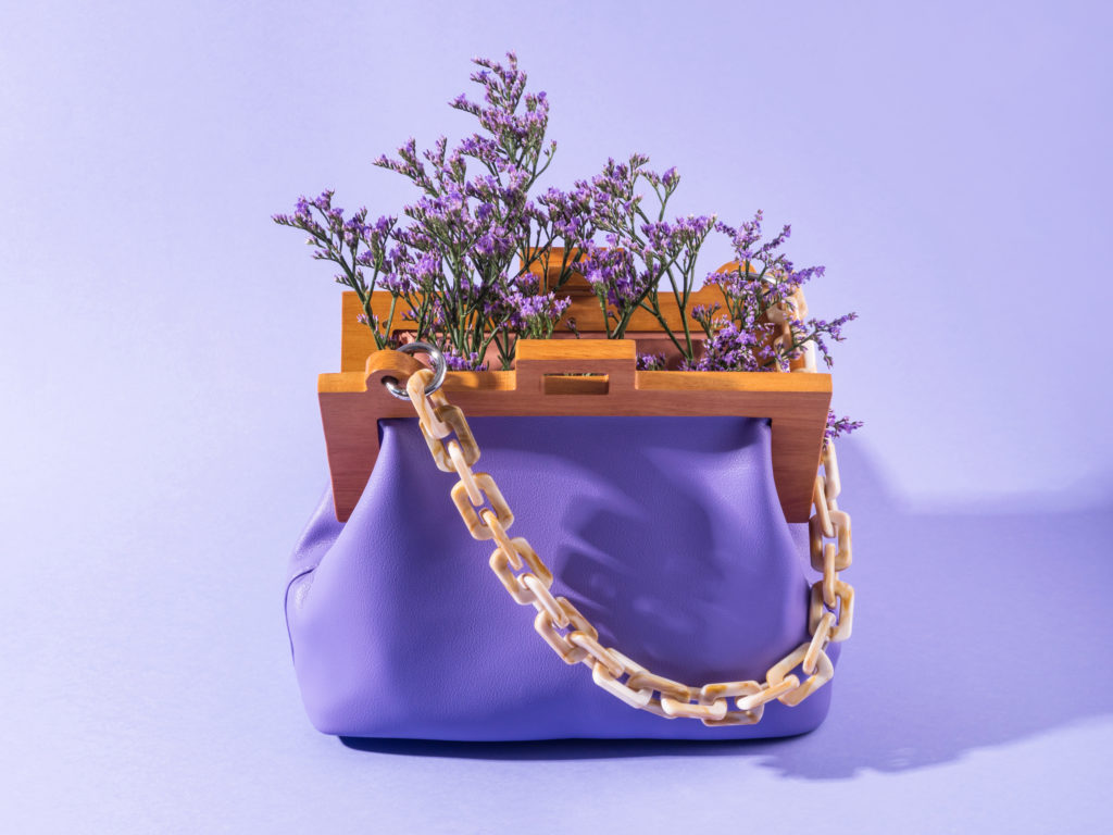 Purple leather fashion accessory handbag with violet flowers